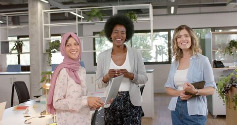 Diverse Female Team Collaborating Happily in Modern Office - Download Free Stock Images Pikwizard.com