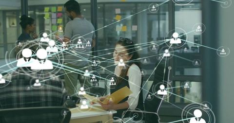 Businesswoman analyzing data in networked office environment