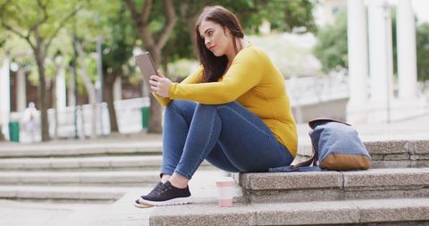 Young Woman Using Tablet Outdoors in City with Coffee Cup - Download Free Stock Images Pikwizard.com