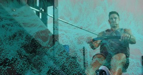 Fit man rowing on ergometer with teal textured overlay, intense indoor cardio training focus