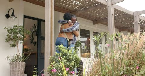 Warm Embrace on Porch with Natural Surroundings