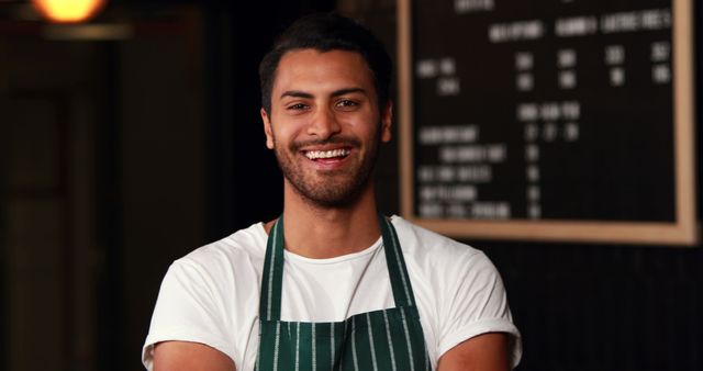 Happy Male Barista in Striped Apron Smiling at Camera - Download Free Stock Images Pikwizard.com