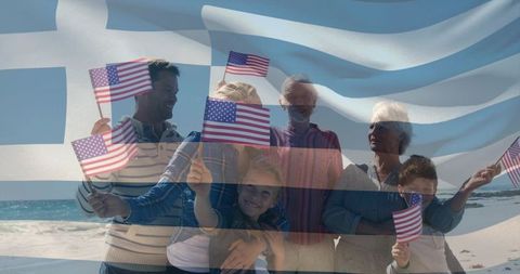 Multigenerational american family waving flags on sunlit greek coastline celebrating heritage
