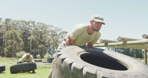 Caucasian Male Soldier Flipping Tire on Army Obstacle Course Outdoors - Download Free Stock Images Pikwizard.com