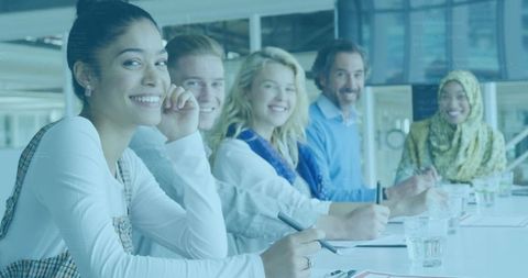 Diverse Group of Smiling Colleagues in Modern Office Meeting