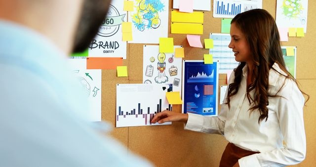 Businesswoman Presenting Marketing Data in Office Meeting - Download Free Stock Images Pikwizard.com