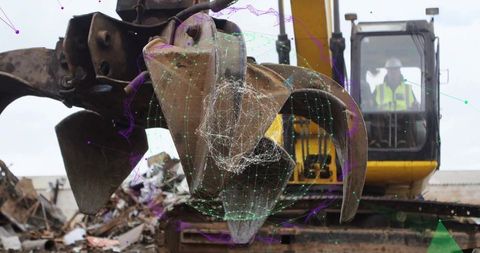 Industrial excavator sorting metal at scrap yard