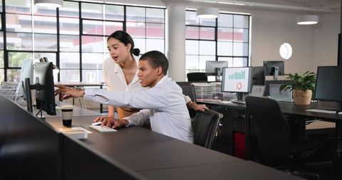 Multiracial Business Team Collaborating on Project in Contemporary Office