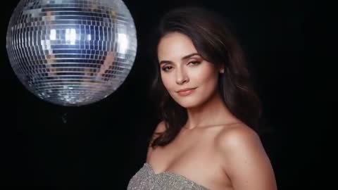 Glamour model posing with disco ball closing eyes in strapless sequin gown portrait video