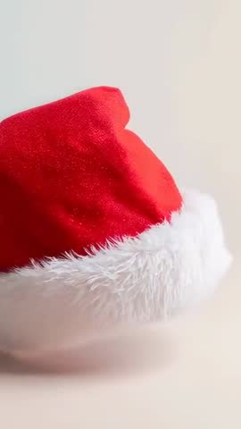 Rotating Santa Hat on Tabletop Vertical Video Loop with Fluffy White Fur Rim