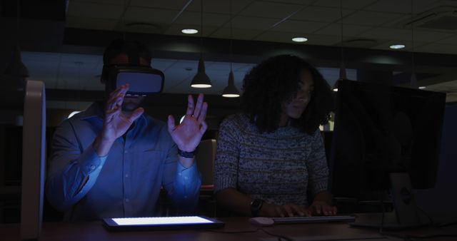 People Experimenting with VR and Typing in Dimly Lit Office - Download Free Stock Images Pikwizard.com