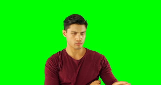 Man in Red Shirt Expressing Concern with Green Screen Background - Download Free Stock Images Pikwizard.com