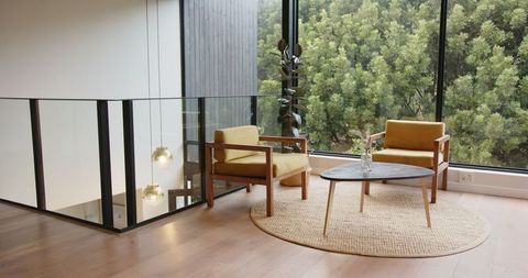 Cozy Modern Seating Area with Mustard Armchairs at Large Window