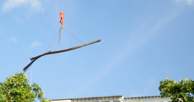 Crane Lifting Industrial Pipe Against Blue Sky - Download Free Stock Images Pikwizard.com