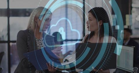 Businesswomen discussing cloud security technology in modern office