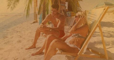 Couple Relaxing on Sandy Beach, Enjoying Sun, Tropical Relaxation