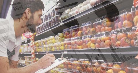 Caucasian Supermarket Worker Analyzing Data Over Fruit Display - Download Free Stock Images Pikwizard.com