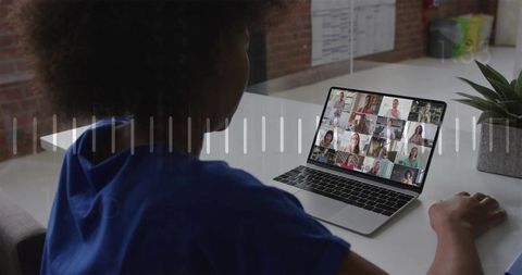 Remote team video conference on laptop in modern minimalist office with woman participating