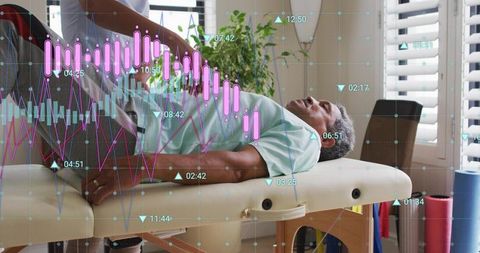 Therapist manipulating senior man knee on clinic table with health data overlay, rehab