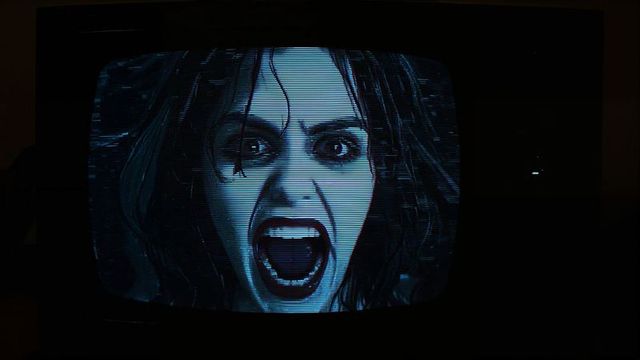 Retro crt tv displaying horror scene with distorted face