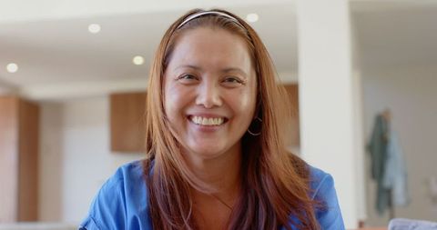 Smiling Asian Woman in Modern Kitchen