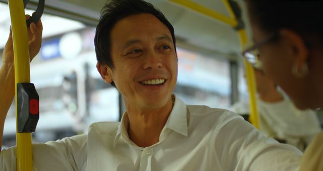 Man Smiling and Interacting on Public Transportation - Download Free Stock Images Pikwizard.com