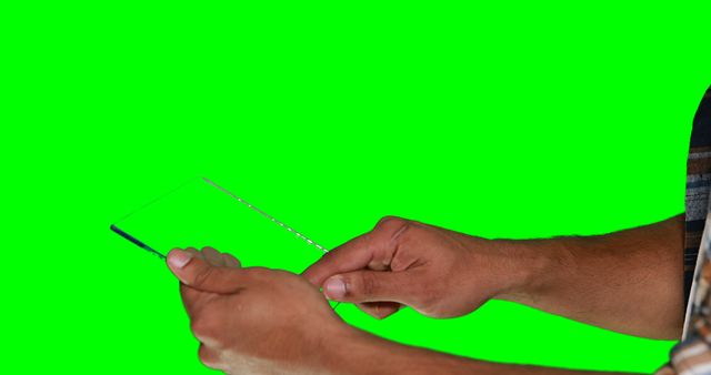 Hands holding transparent tablet over green screen background, ideal for presentations on futuristic technology. Can be used for business, tech campaigns, or educational content showcasing future digital interface concepts.