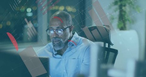 Businessman Analyzing Data on Computer with Futuristic Graph Overlays