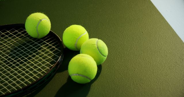 Four Tennis Balls Besides Tennis Racket on Green Court - Download Free Stock Images Pikwizard.com