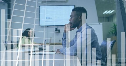 Business Professional in Office Analyzing Financial Data and Graphs