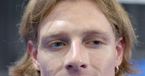 Close-Up Portrait of Adult Man with Long Hair and Hoop Earring