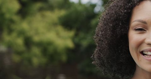 Happy Biracial Woman Smiling in Sunny Garden