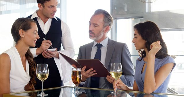 Business Meeting in Elegant Restaurant with Waiter Taking Order - Download Free Stock Images Pikwizard.com