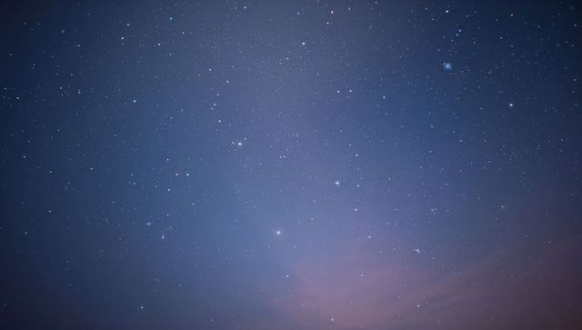 Stars Filling Night Sky Over Distant Horizon with Soft Airglow and Twinkling Nebula Hues
