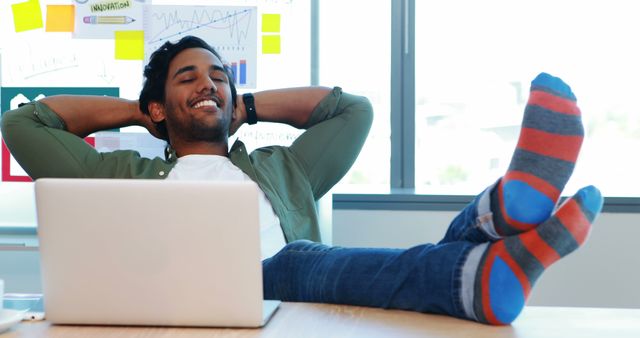 Happy Man Relaxing at Desk with Feet Up on Laptop, Creative Workspace - Download Free Stock Images Pikwizard.com