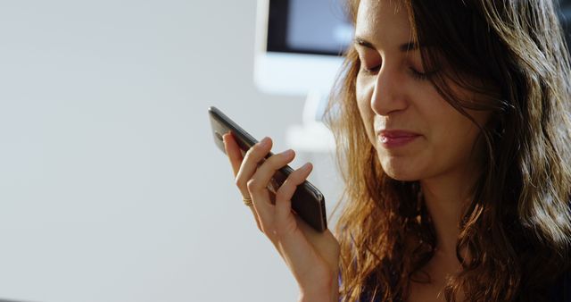 Smiling Woman Using Voice Command Feature on Smartphone - Download Free Stock Images Pikwizard.com