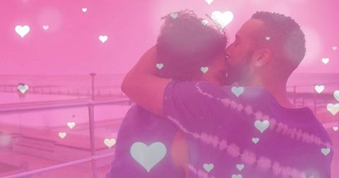 Romantic Couple Embracing at Seaside Promenade with Heart Overlay