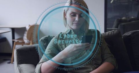 Blonde Woman Holding Smartphone in Lounge Showing Cyber Security Digital Overlay