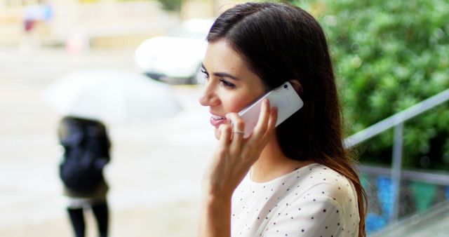 Woman Talking on Phone Outdoors in Rainy Weather - Download Free Stock Images Pikwizard.com