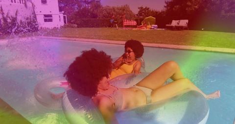 Friends relaxing on pool floats in vibrant summertime scene