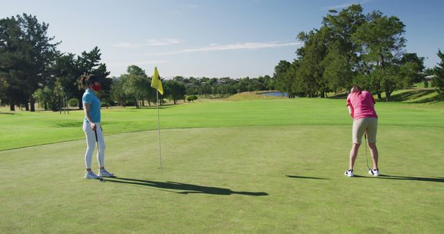 Golfers on a Bright Day Playing Golf on Green Course - Download Free Stock Images Pikwizard.com