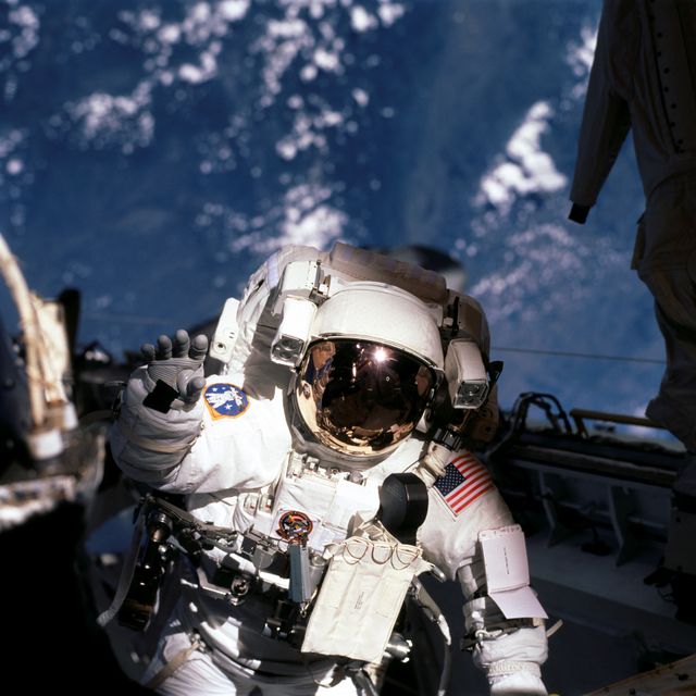STS105-725-024 (16 August 2001) --- Astronaut Patrick G. Forrester, STS-105 mission specialist, waves at a crew member inside Discovery's cabin during one of two sessions of extravehicular activity (EVA). Astronaut Daniel T. Barry, mission specialist, joined Forrester on both space walks.