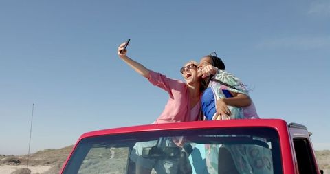 Joyful Friends Taking Selfie on Road Trip Adventure