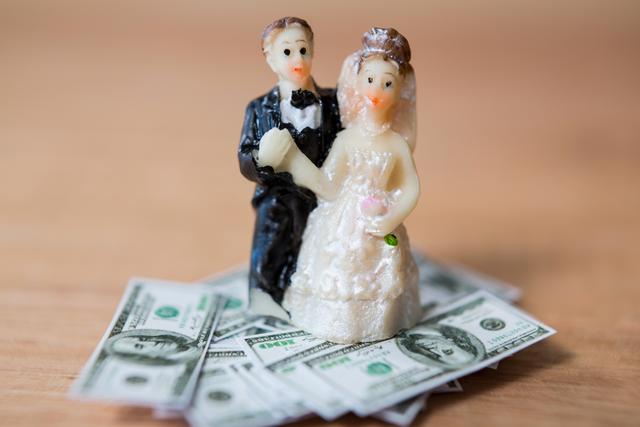 Miniature Bridal Couple Standing on Dollar Bills - Download Free Stock Photos Pikwizard.com