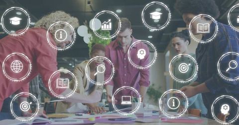 Collaborating team brainstorming around table with digital business icons overlay