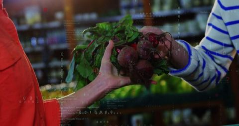 Close-up of clerks exchanging fresh beetroots in grocery aisle