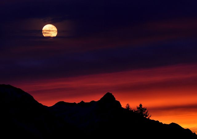 Dramatic Evening Sky with Full Moon Over Mountain Silhouette - Download Free Stock Photos Pikwizard.com
