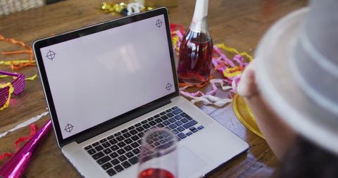 Festive Virtual Celebration with Laptop and Party Decorations