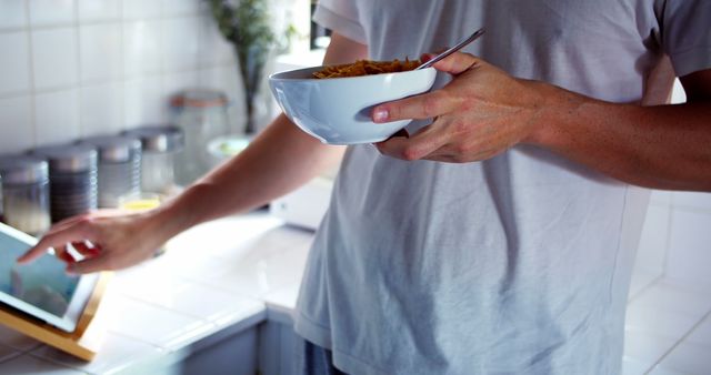 Man Having Breakfast While Using Digital Tablet in Kitchen - Download Free Stock Images Pikwizard.com