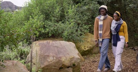 African American Couple Walking Trail in Scarves and Cozy Fall Clothing, Serene Stroll